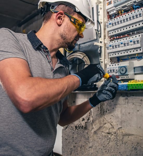 man-electrical-technician-working-switchboard-with-fuses