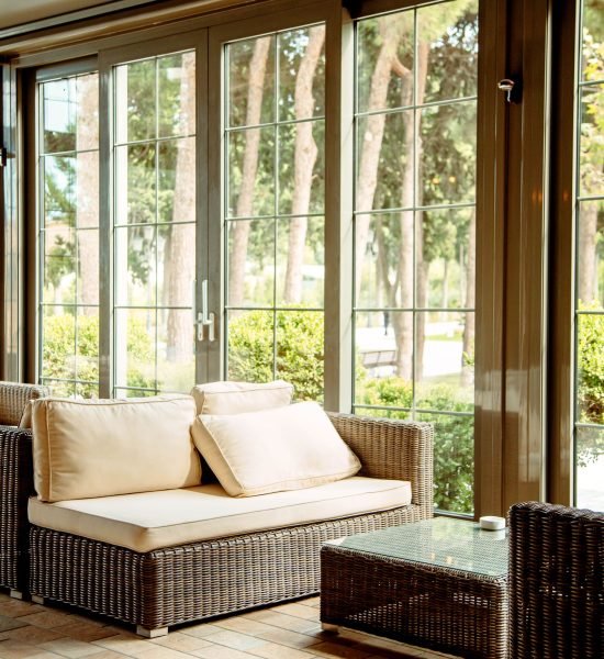 outdoor-sofa-with-beige-cushions-coffee-table-front-restaurant-window